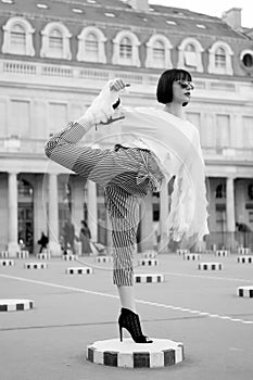 Woman stretch leg on square in paris, france