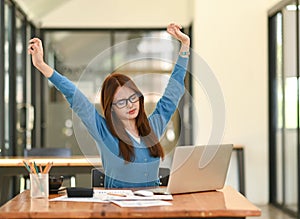 Woman stretches her arms when tired in the office, business woman relaxes, office syndrome