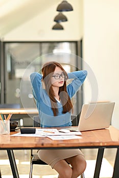 Woman stretches her arms when tired in the office, business woman relaxes, office syndrome