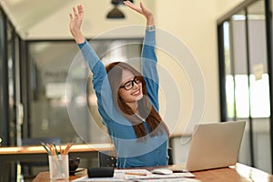 Woman stretches her arms when tired in the office, business woman relaxes, office syndrome