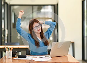 Woman stretches her arms when tired in the office, business woman relaxes, office syndrome
