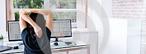 Woman Stretches At Office Desk Chair While