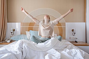 Woman stretching in bed after wake up