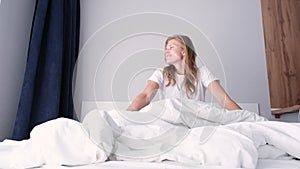 Woman stretching in bed after wake up