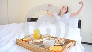 Woman stretching in bed after wake up