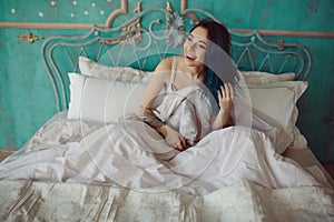 Woman stretching in bed after wake up