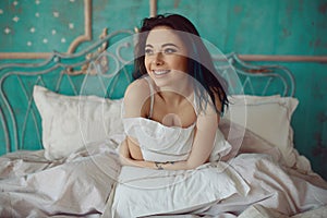 Woman stretching in bed after wake up