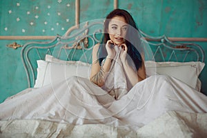 Woman stretching in bed after wake up