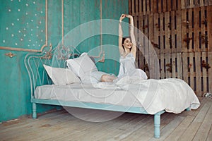 Woman stretching in bed after wake up