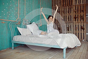 Woman stretching in bed after wake up