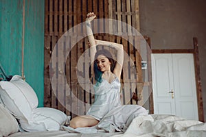 Woman stretching in bed after wake up