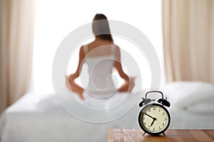 Woman stretching in bed after wake up, back view, entering a day happy and relaxed after good night sleep. Sweet dreams