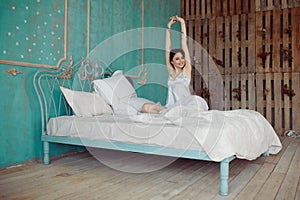 Woman stretching in bed after wake up