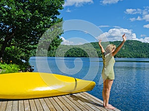 Woman stretching before diving off the dock into lake