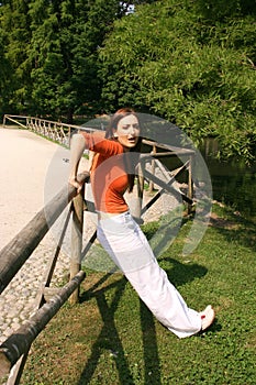 Woman stretching on fence