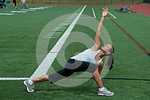 Woman Stretching on Field