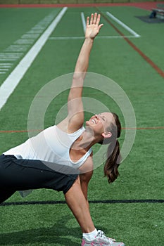 Woman Stretching on Field