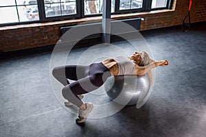 Woman stretching on fitness pilates ball