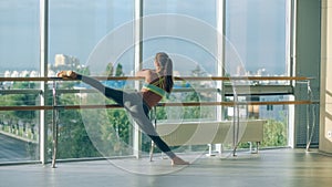Woman stretching her leg at the barre