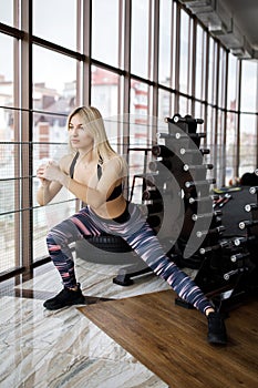 Woman stretching her legs and back at the gym. Active Lifestyle. Sports in the gym