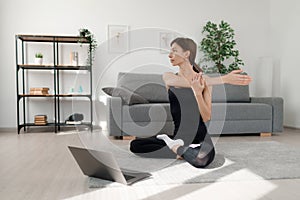 Woman stretching with laptop