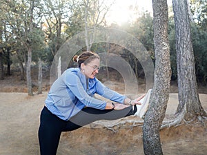 Woman Stretching Leg Muscles in a Peaceful Forest Environment