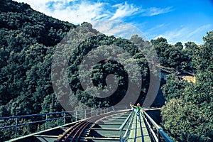 Woman stretching leg on rail bridge