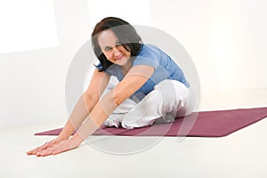 Woman stretching on mat