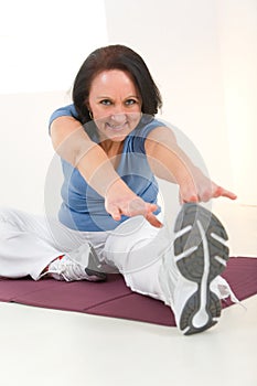 Woman stretching on mat