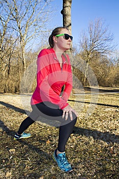 Woman stretching before a morning jog in the park