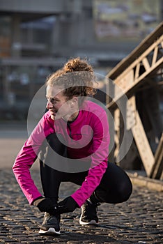 Woman stretching before morning jogging