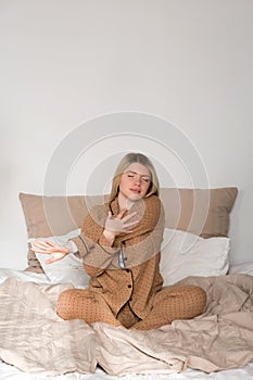 Woman stretching in pajamas with smartwatch