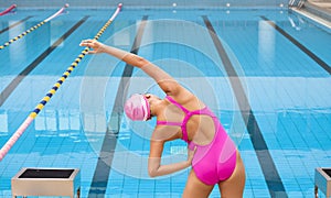 Woman stretching and preparing to swimming