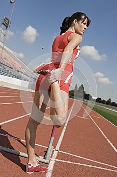 Woman Stretching On Racetrack