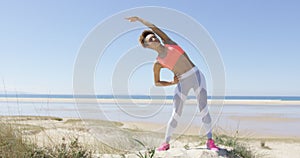 Woman stretching by the sea