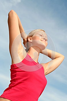 Woman stretching in sunlight