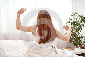 Woman stretching after waking up Entering a day happy after good night sleep