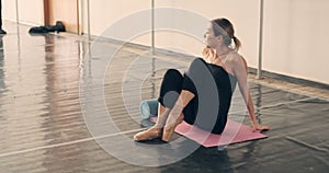 Woman stretching and warming up using foam roller