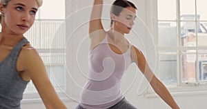 Woman, stretching and yoga class in fitness, exercise or training for pilates, wellness or warrior pose in studio. Group