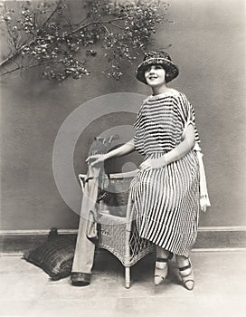 Woman in striped dress with golf clubs