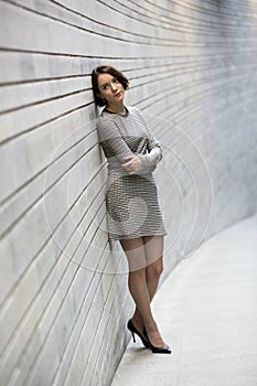 Woman at striped dress and wall of bricks