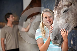Woman stroking her horse