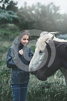 A woman stroking a horse