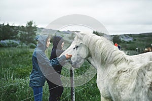 A woman stroking a horse