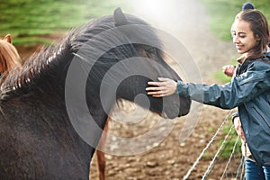 A woman stroking a horse