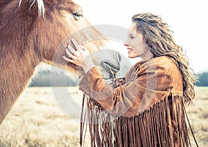 Woman stroking horse photo