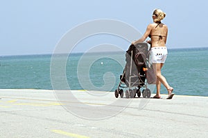 Woman with a stroller on beach