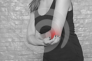 Woman struggles with elbow pain, injury