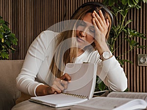 Woman struggling with ADHD and dyslexia, holding head in frustration, problems with reading. Learning difficulties and photo