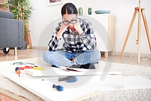 Woman struggling with challenges and difficulties that can arise when taking on a DIY renovation project